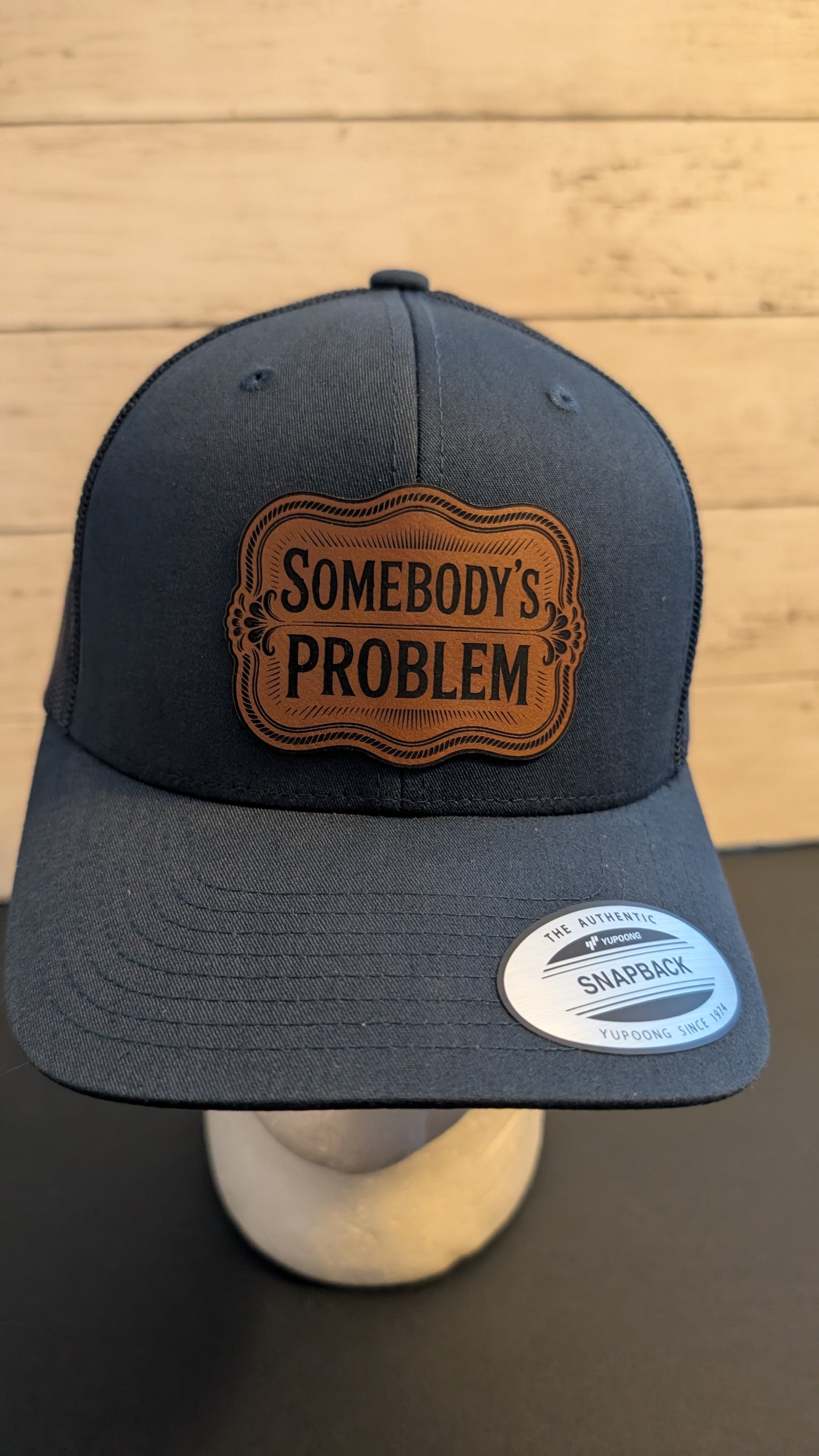 "Somebody’s Problem" Leatherette Patch Hat | Navy Blue Yupoong Snapback