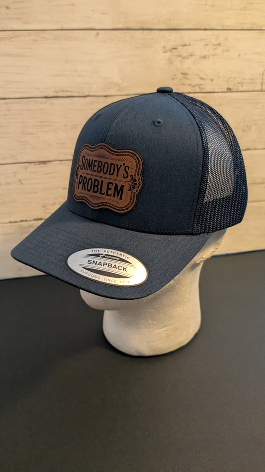 "Somebody’s Problem" Leatherette Patch Hat | Navy Blue Yupoong Snapback